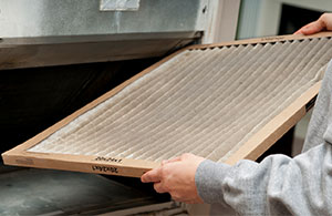 Person changing the HVAC filter