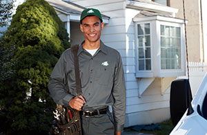 Service tech in front of a house