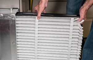 Person changing HVAC filter 