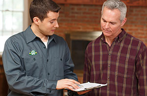 ai_natgastuneup Service tech reviewing invoice with customer