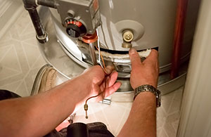 Person fixing water heater