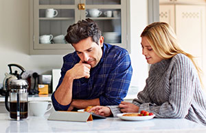 ai_replacefurnace_4 Couple reviewing invoice on iPad