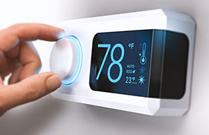 Hand adjusting digital thermostat