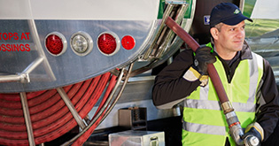 Service tech next to oil truck